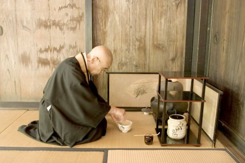 A monk performs a tea ceremony